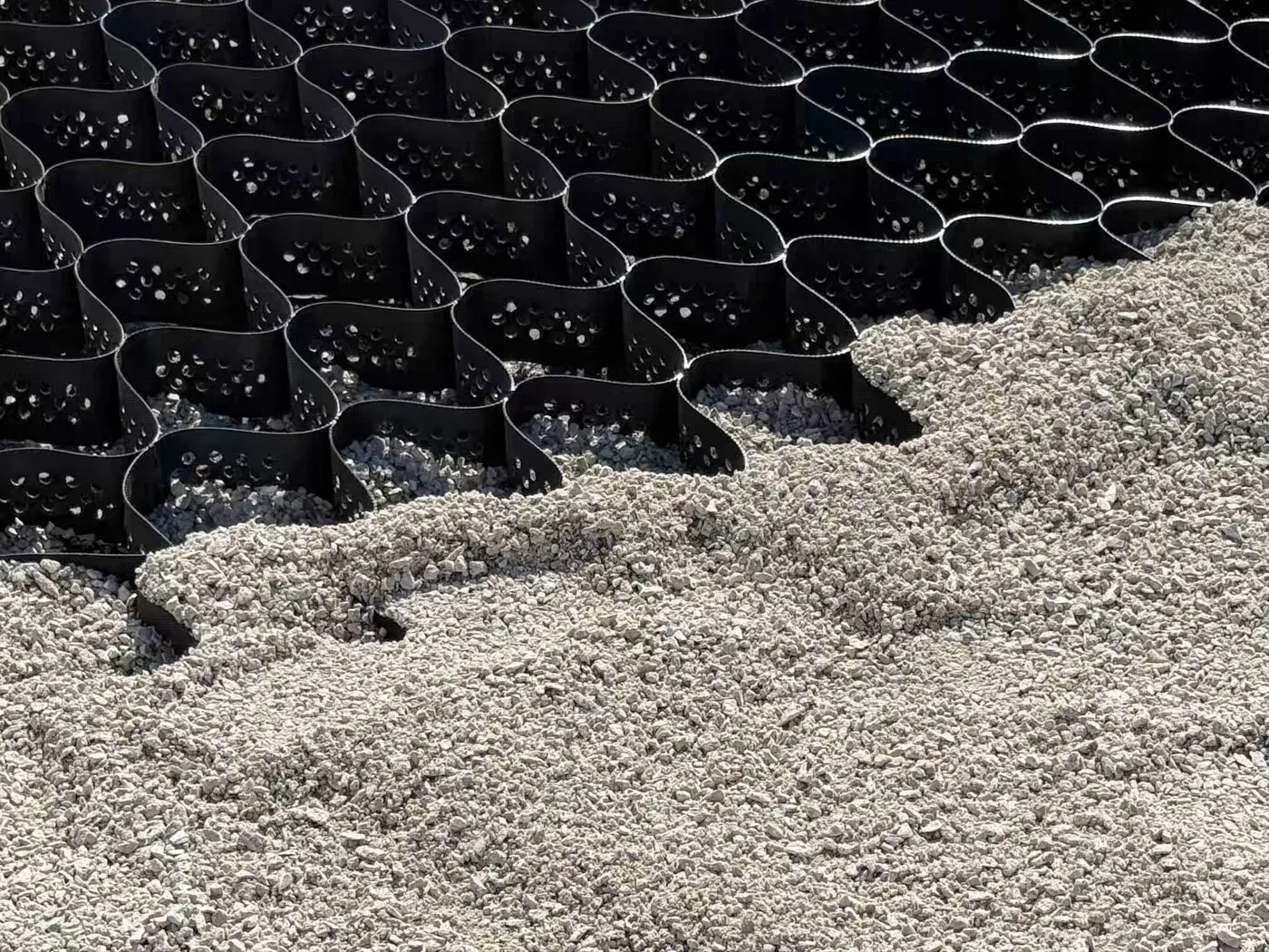 Geocell panels being filled with angular aggregate on a Jenterra jobsite